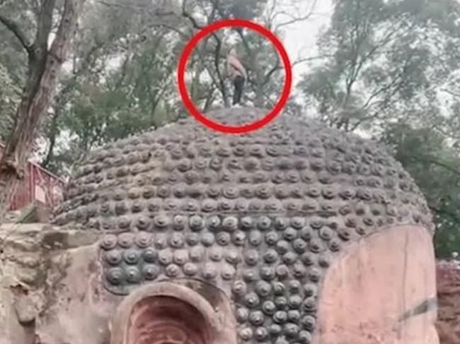 ONE TIME WEB USE FOR NEWS.COM.AU ONLY - FEES APPLY -  Story from Jam Press (Urinate On Buddha)   Pictured: The man urinating on top of a Buddha statue.  Tourist sparks fury by Ã¢â¬ËURINATINGÃ¢â¬â¢ on giant BuddhaÃ¢â¬â¢s head at UNESCO site  A tourist has sparked fury by urinating on a giant Buddha statue at a UNESCO World Heritage Site.  The man took advantage of a CCTV blind spot, scaling a fence and climbing on top of the statue.  He then paraded around on the monumentÃ¢â¬â¢s head before allegedly urinating in front of scores of visitors on 31 January.  After being informed of what was happening, security guards rushed to remove the man from the Leshan Giant Buddha.  The monument is based in the Mount Emei Scenic Area, located in Sichuan Province, China.  The 233-foot-tall statue was carved out of a cliff face between 713 and 803 AD.  With the confluence of the Min and Dadu rivers flowing below its feet, the Buddha sculpture faces Mount Emei.  It is considered the largest and tallest stone Buddha statue in the world.  The Mount Emei Scenic Area has been listed as a UNESCO World Heritage Site since 1996.  After being detained, the man was handed over to the police who took him to a nearby hospital to undergo a psychiatric evaluation.  If found to be in a healthy mental state, the suspect will be punished in accordance with the law.  ENDS