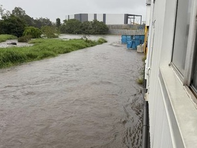A nearby creek near Fairfield Road flooded and had begun creeping towards nearby residential buildings at Rocklea. Picture: Michelle Pavey
