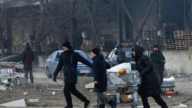 Civilians head to a humanitarian corridor from the embattled city of Mariupol hit by Russian bombing. Picture: AAP