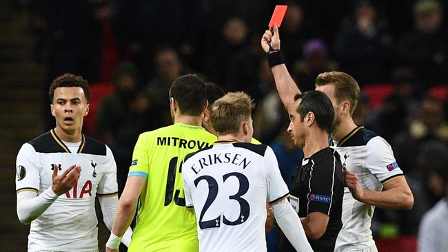 Portuguese referee Jorge Sousa (R) shows a straight red card to send off Tottenham Hotspur's English midfielder Dele Alli (L).