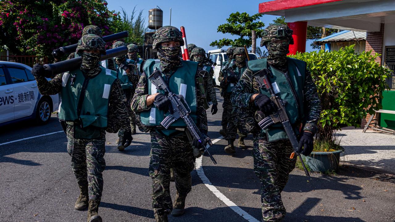 Soldiers take position during the Han Kuang military exercise, which simulates China's People's Liberation Army (PLA) invading the island, on July 28, 2022 in Pingtung, Taiwan.