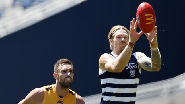 Tom Stewart leads Jack Gunston to the ball in the Cats’ February 17 practice match. Picture: Michael Klein