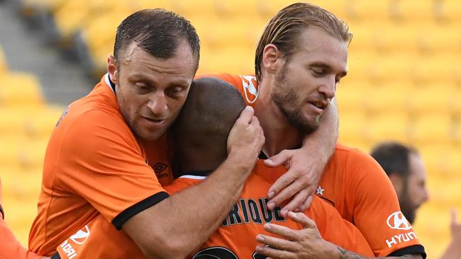 Brisbane Roar players celebrate Henrique’s (centre) goal on Saturday. 