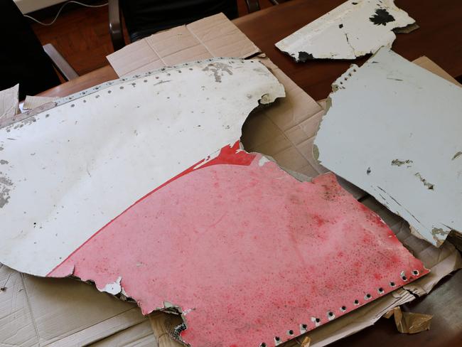 Three pieces of aircraft wreckage — including one a dramatic pink and white — found off the east African coast of Mozambique earlier this month, on display in Maputo on September 5. Picture: Adrien Barber.