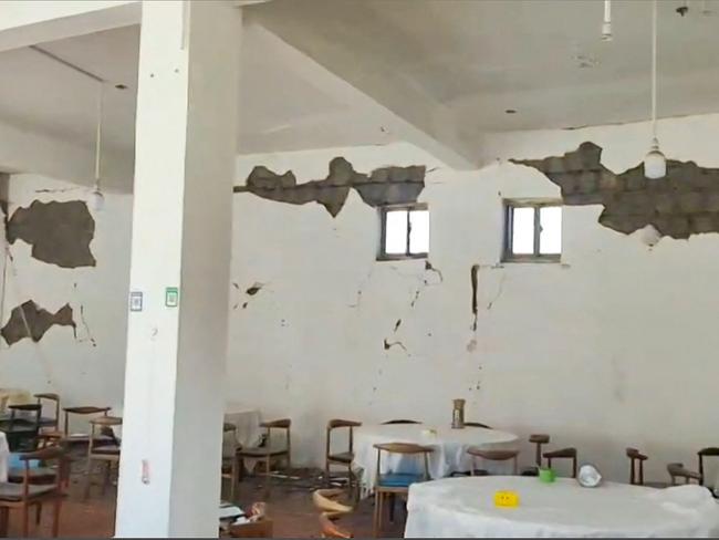 Cracks on the walls of a restaurant in Lhatse County in China's Tibet after an earthquake struck the area. Picture: AFP