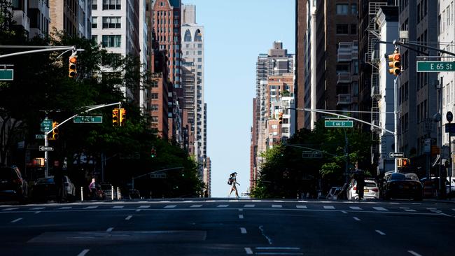 A couple crosses an avenue in Manhattan. Picture: AFP