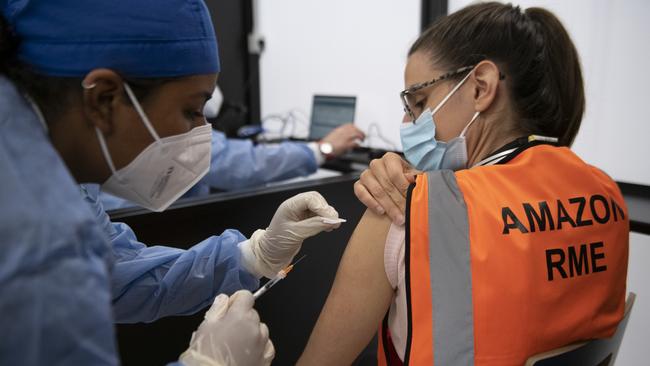 A worker is vaccinated at the Amazon Headquarters in Torrazza Piemonte near Turin, Italy. Picture: Getty Images