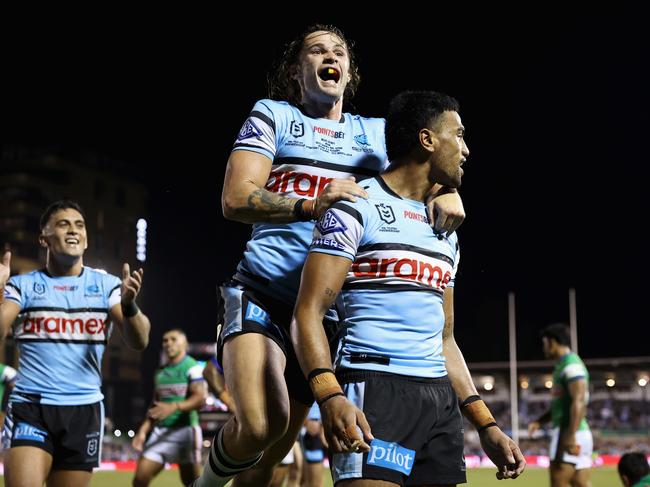 SYDNEY, AUSTRALIA - MARCH 31: Ronaldo Mulitalo of the Sharks celebrates scoring a try with Nicho Hynes of the Sharks during the round four NRL match between Cronulla Sharks and Canberra Raiders at PointsBet Stadium, on March 31, 2024, in Sydney, Australia. (Photo by Cameron Spencer/Getty Images)