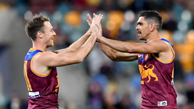 Lions pair Lincoln McCarthy (left) and Charlie Cameron celebrate a recent QClash win. Picture: AAP Image/Darren England