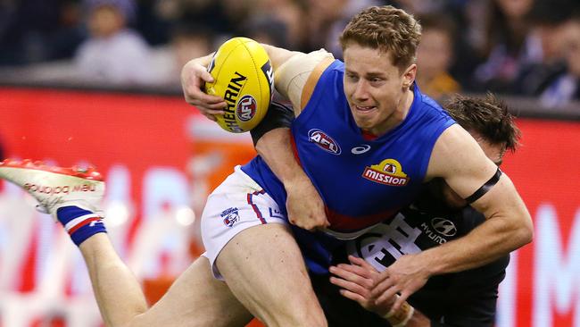 Carlton's Dale Thomas locks up Lachie Hunter and wins a free kick close to the boundary. Pic: Michael Klein