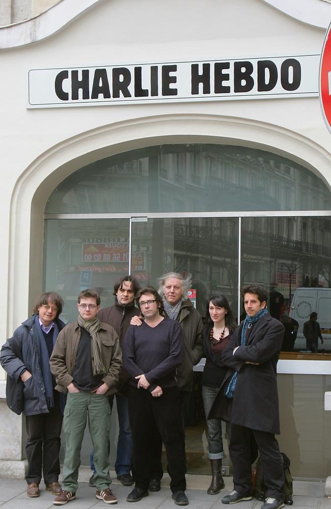 Staff ... members of the French satirical newspaper Charlie Hebdo pictured in 2006, including cartoonists Cabu (L), Charb (2nd L), Tignous (4th L) and Honore (5th L) posing in front of the then headquarters of the weekly in Paris. Picture: Joel Saget