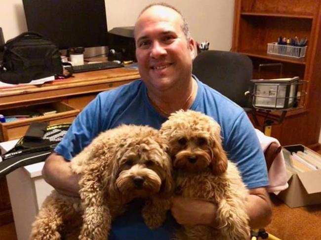 Chris Koupparis, administrator of Oodle Owners Australia Facebook page, with his cavoodles Evie May and Mia Rose.