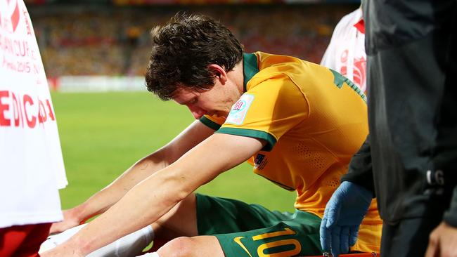 Robbie Kruse is taken from the field injured during the Asian Cup final.