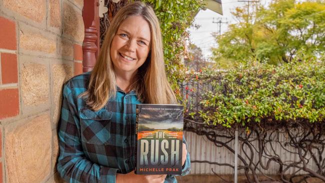 Author Michelle Prak with a copy of The Rush.