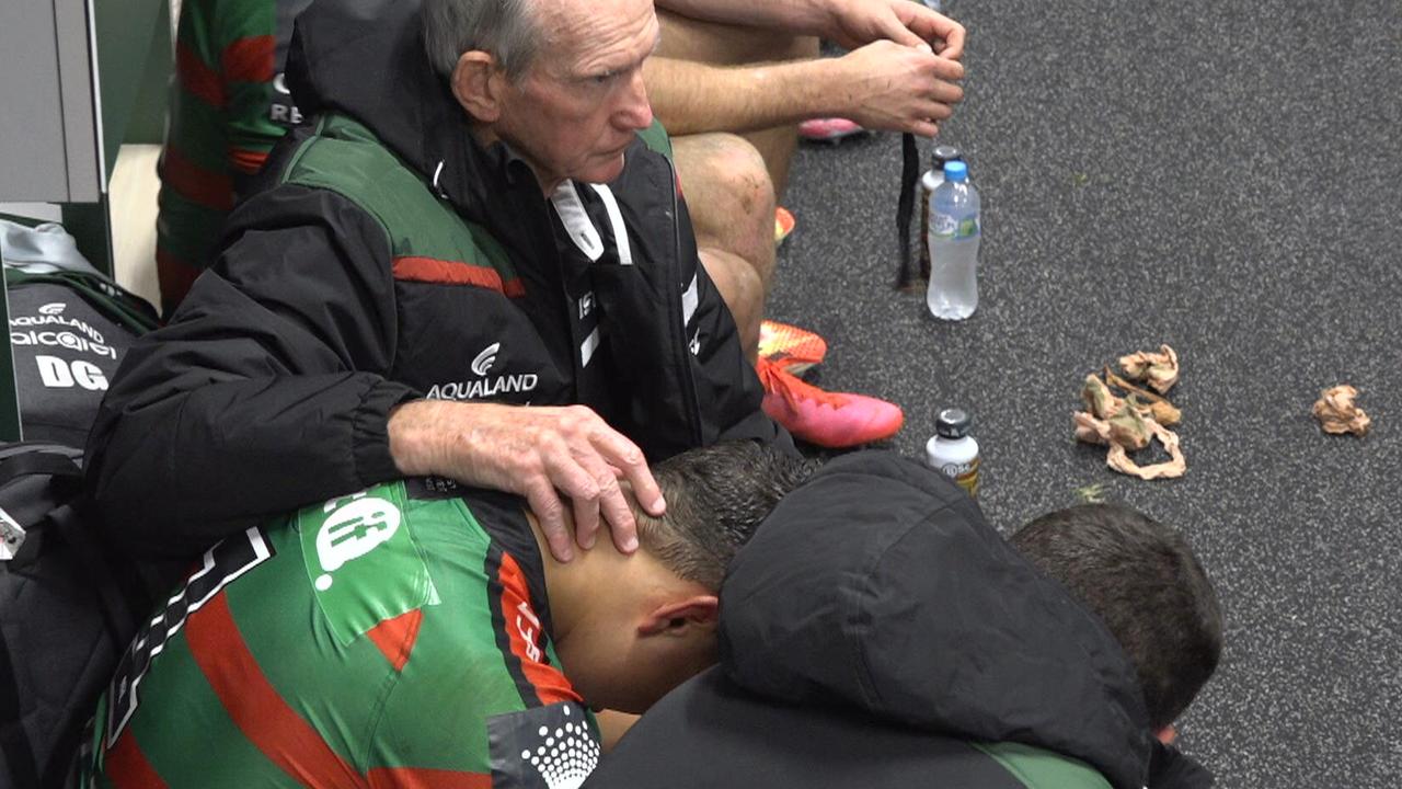 Latrell Mitchell receives support from Bunnies teammates and coach Wayne Bennett