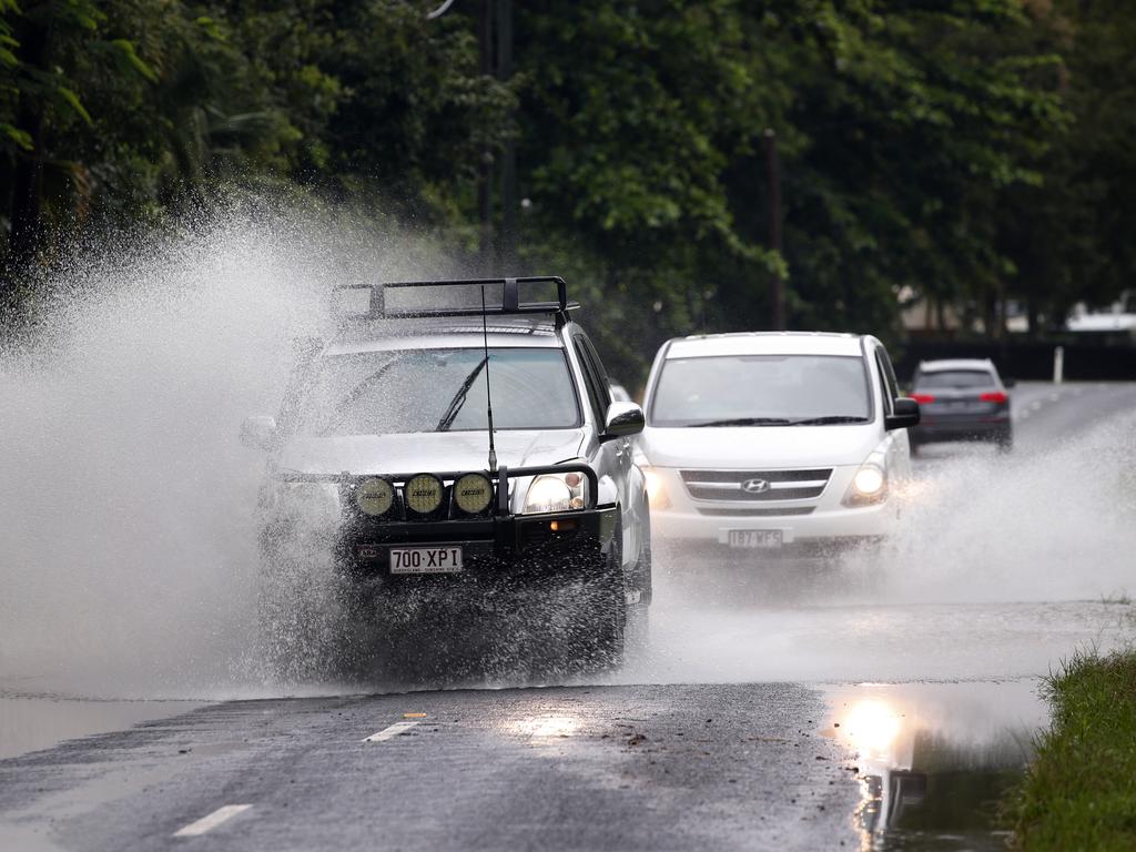 Cars drive through water on Lower Freshwater Rd in Kamerunga after the rain overnight in Cairns Picture: Anna Rogers