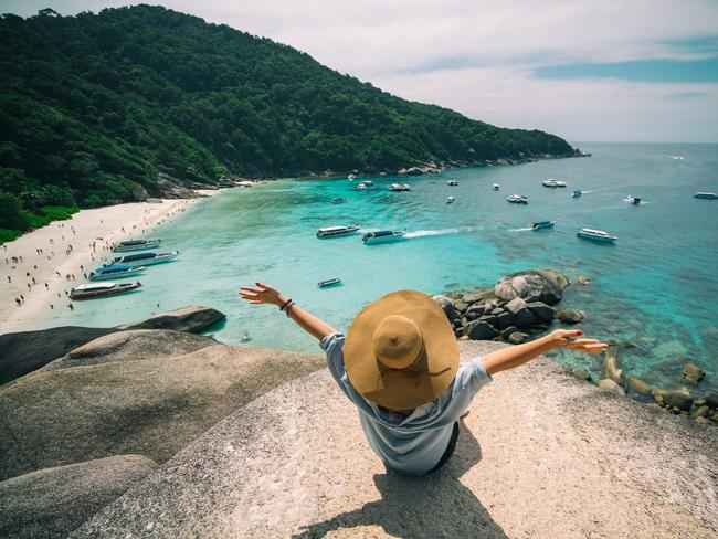 Rear view of young woman traveler with hat sitting and relaxing on viewpoint at similan islands in Andaman sea at Phang Nga province near Phuket and Krabi in southern of Thailand. Picture: iStockDoc HOliday, Escape