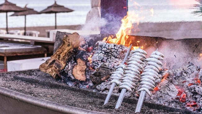 <h2>Find a restaurant a couple of streets back from the beach</h2><p>If your stomach is really rumbling, find an espeto place to try charred sardines cooked over a wooden boat. Bonus tip: oily almonds and fresh tuna (caught using the traditional almadraba method, if you're in the south) are usually to die for, too. Just walk a couple of streets back from the beach into town and you're sure to find something good value. </p>