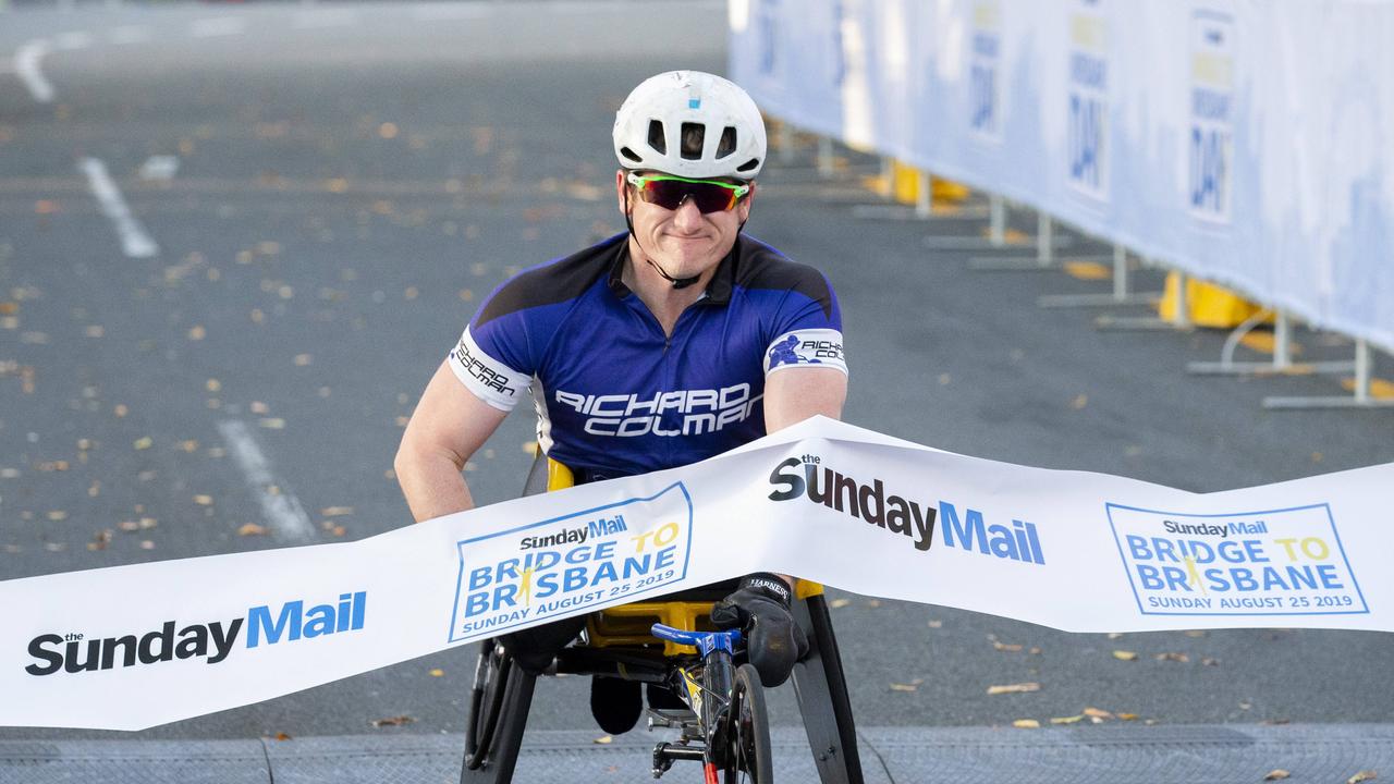 Richard Colman crosses the finish line at the Bridge to Brisbane 2019 at South Bank. Picture: Richard Walker/AAP