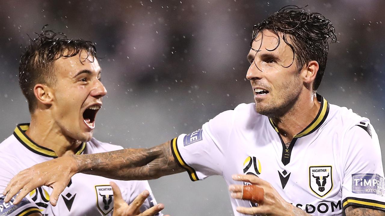 Denis Genreau congratulates Matt Derbyshire of Macarthur FC as he celebrates scoring a goal during the A-League match against Adelaide United.