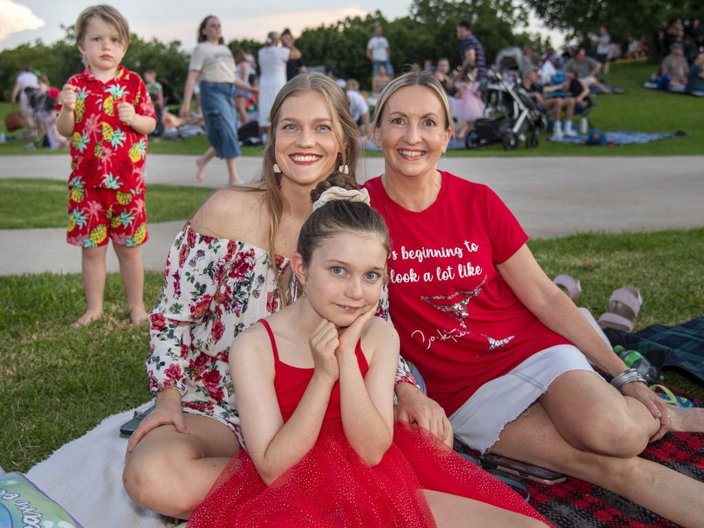 3 generations (from left) Eliza Marshall, Esther Britt and Faye Shann with Jedidiah Britt in background. Triple M Mayoral Carols by Candlelight. Sunday 8th December, 2024. Picture: Nev Madsen.