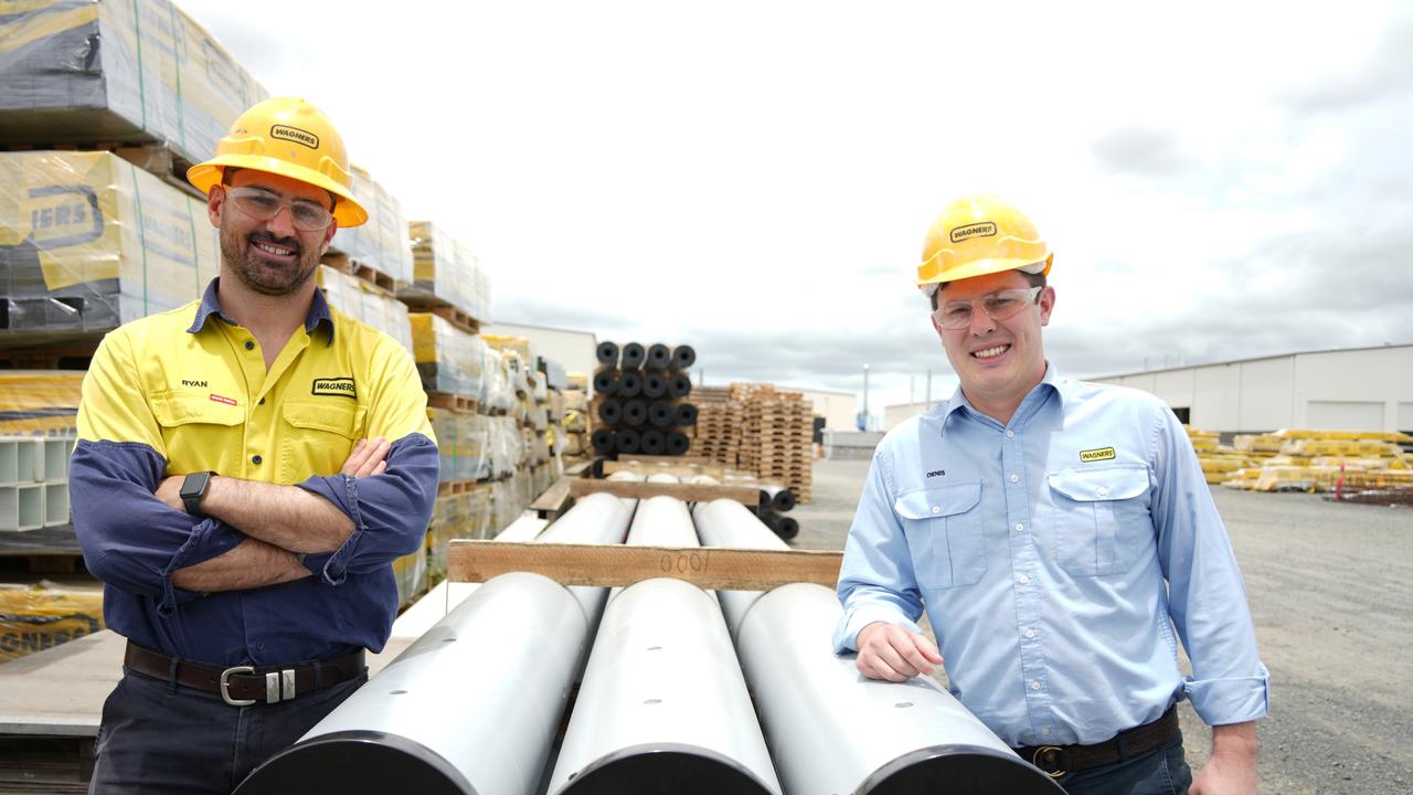 Showcasing the length of Wagners' new power poles, made from the company's composite-fibre technology, are CFT Australia and New Zealand general manager Ryan Leeson and president of North American operations Denis Wagner Jr.