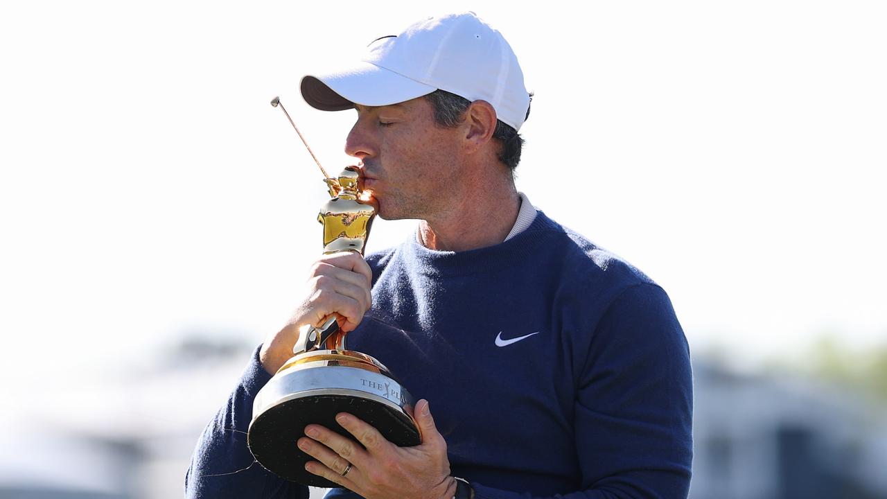 Rory McIlroy for a photo with the trophy after beating JJ Spaun.