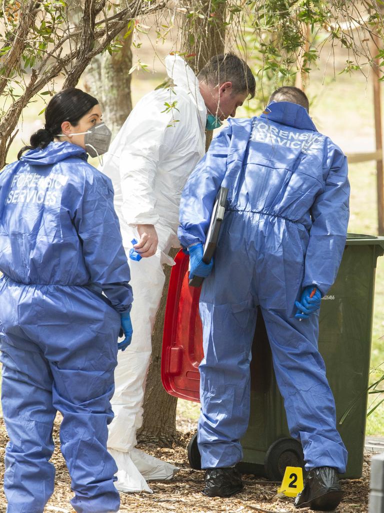 Officers examine a bin at the playground. Picture: Jenny Evans.