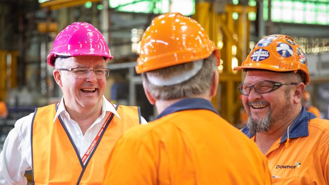 Anthony Albanese visits Downer EDI, a train maker, in Maryborough on Friday, where he met Ken, centre, and Peter.