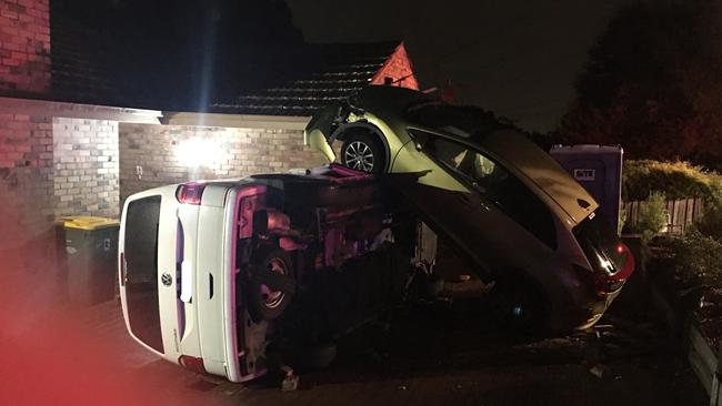 The car went over the front fence before hitting the van.