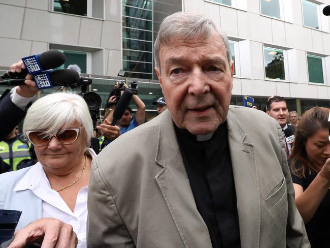 (FILES) In this file photo taken on February 26, 2019 Cardinal George Pell (C) leaves the County Court of Victoria court after prosecutors decided not to proceed with a second trial on alleged historical child sexual offences in Melbourne. - Disgraced Australian Cardinal Pell was sentenced to six years in jail for child sex crimes in a Melbourne court on March 13, 2019, with a non-parole period of three years and eight months. (Photo by Asanka Brendon Ratnayake / AFP)