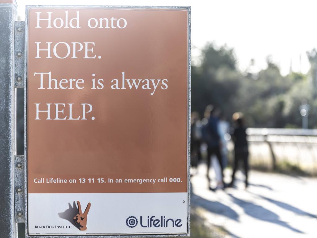 Lifeline signs similar to this Sydney one have been put near hotspots for people going onto train tracks around Melbourne. Picture: NCA NewsWire / Monique Harmer