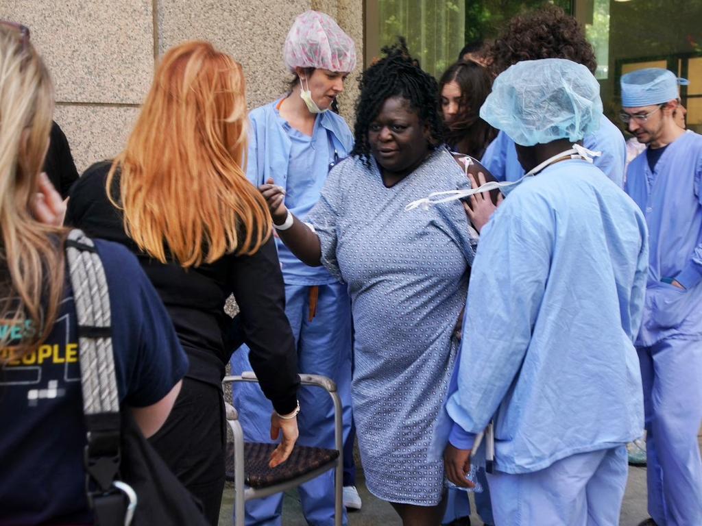 A patient is evacuated from a hospital after a man shot four people in a building in Atlanta. (Photo by Elijah NOUVELAGE / AFP)