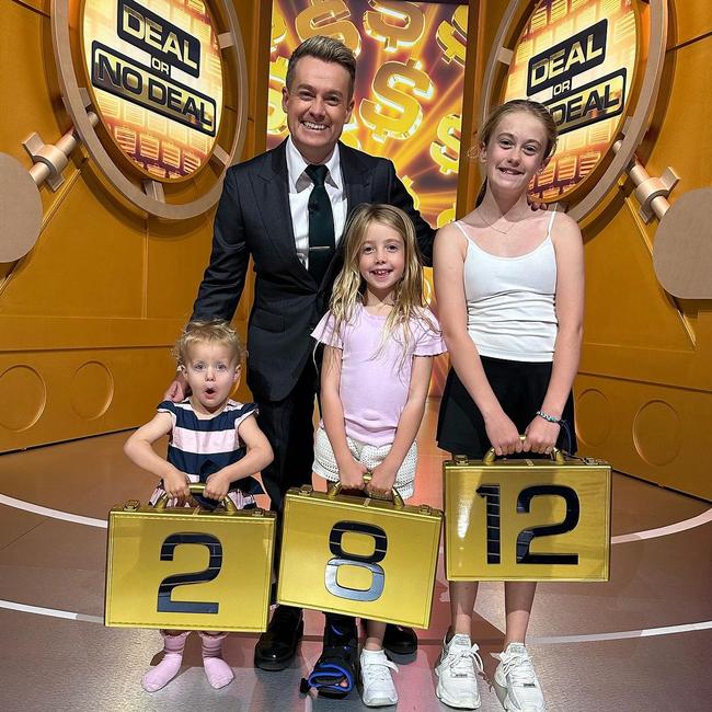 Grant Denyer and his three daughters – Sailor, Scout and Sunday – on the set of Deal or No Deal. Picture: Instagram