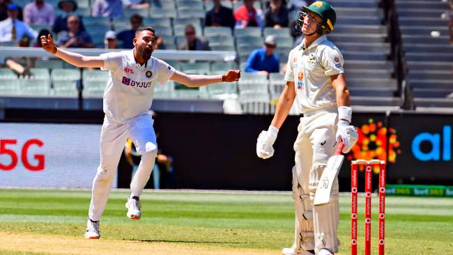 India's Mohammed Siraj (L) celebrates dismissing Australia's Marnus Labuschagne (R).