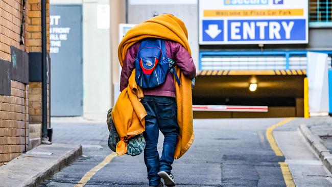 A man carries all his possessions on his back in Adelaide. Picture: Russell Millard