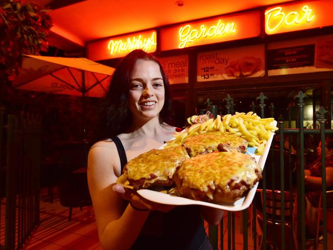 Shamrock Hotel Bartender Courtenay Millar with the 3kg Parmi Challenge plate which involves eating 2.5 kgs worth parmigiana and 1kg of chips and salad in 20 minutes.