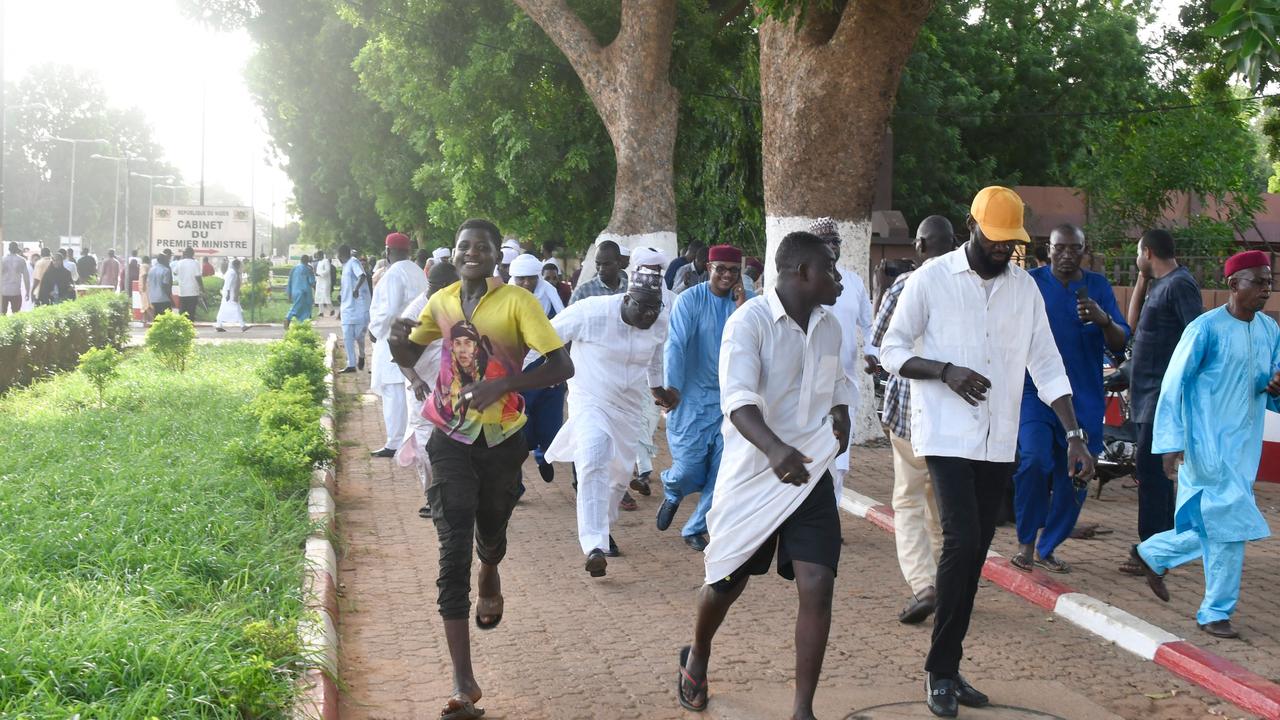 Demonstrators flee after warning shots were fired as they gathered to protest the detention of President Mohamed Bazoum by the Presidential Guard in Niamey on July 26, 2023. Picture: AFP