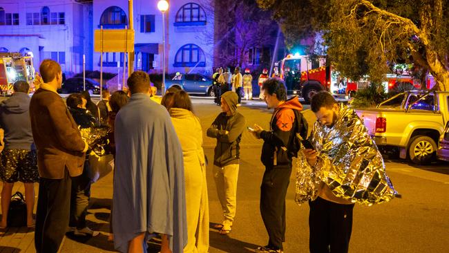 Residents were forced onto the streets as they waited for fire crews to extinguish the blaze. Picture: Damian Hofman