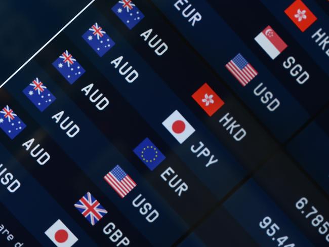 Currency prices are seen on display at a bank on a street in Sydney on October 7, 2014. The Australian dollar hit a four-year-low of 86.43 US cents in New York last week as Australia's economy struggles to transition away from resources-led growth following an unprecedented boom in mining investment that is expected to fall-off sharply over the next year. AFP PHOTO/Peter PARKS