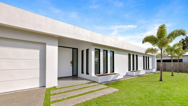 A single-level home, Poolwood combines traditional white with pops of black and grey to accentuate the open-plan design.