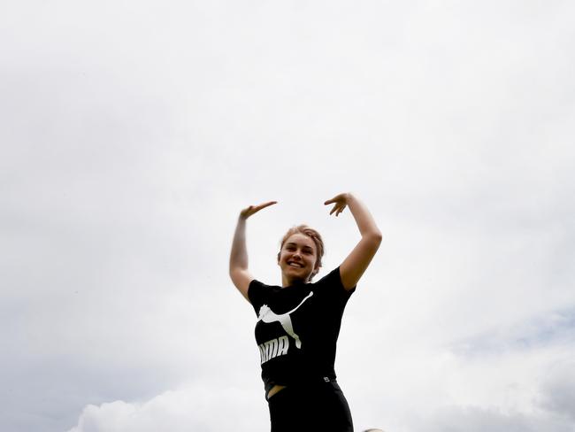 Maddie Ungar jumps for joy as the weather cools off as we get rain. Picture: KATRINA BRIDGEFORD