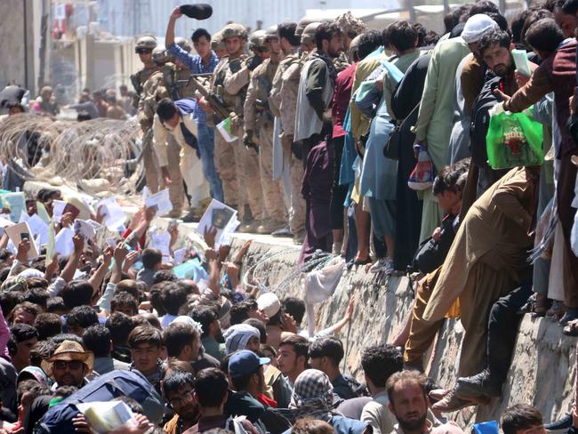 Afghans struggle to reach the foreign forces to show their credentials to flee the country outside the Hamid Karzai International Airport, in Kabul, Afghanistan, on August 26, 2021. At least 13 people including children were killed in a blast outside the airport that day. Picture: Akhter Gulfam/EPA