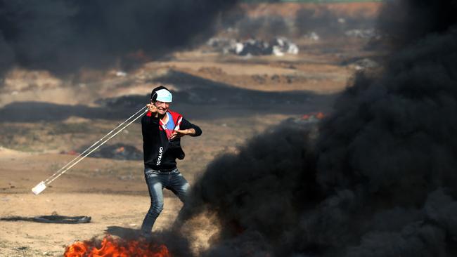 A Palestinian youth hurls a stone during clashes with Israeli forces on May 15, 2018 near the border fence with Israel east of Jabalia in the central Gaza Strip. Picture: AFP