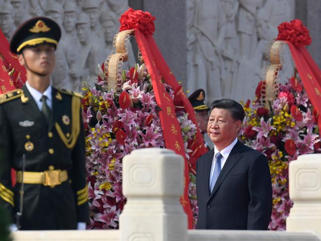 China's President Xi Jinping (C) walks around the Monument to the People's Heroes on Tiananmen Square during a wreath-laying ceremony marking Martyrs' Day at Tiananmen Square in Beijing on September 30, 2019. (Photo by MADOKA IKEGAMI / POOL / AFP)