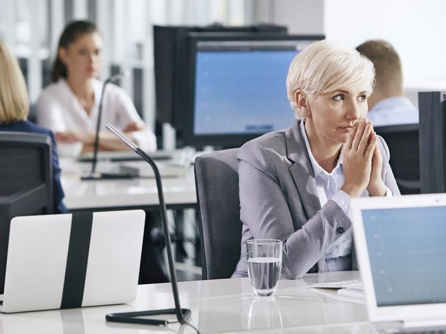 Woman in workplace sitting in front of computer. Full of doubts, hoping for good decisions. Photo: istock