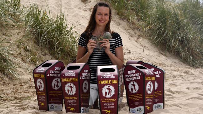 Kellie Lindsay from Gold Coast Marine Debris Network with bins to stop littering with fishing line and hooks and help protect local birds. Photo: Steve Holland