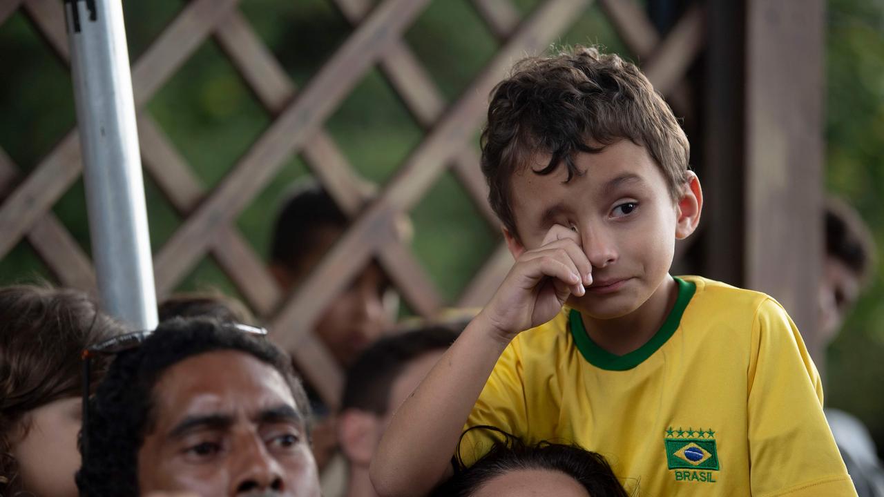 Fans of the Brazilian national football team wait as the Brazilian Football Confederation (CBF) decides if allowing public into a training session