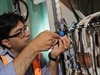 A technician connects apartments to the National Broadband Network