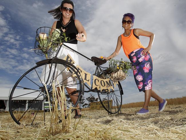 Bec Chamberlain, Merbein and Jules Prins, from Ouyen take a fancy to the welcome bike at the Rupanyup Barley Banquet. Picture: Yuri Kouzmin